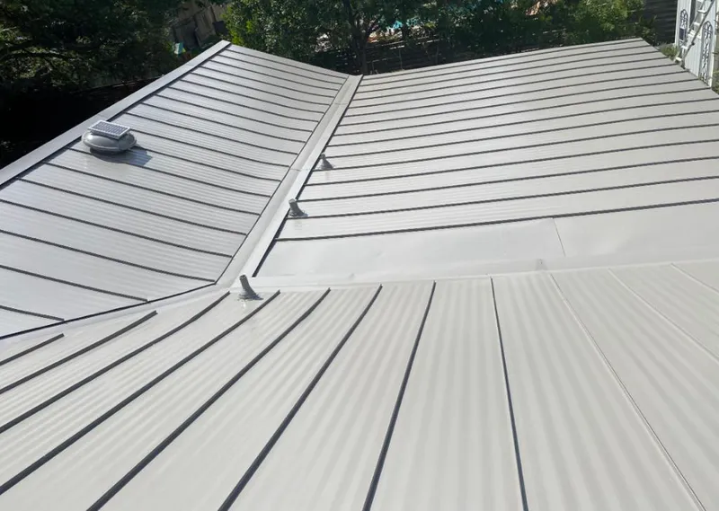 Solar attic fan installed on a metal roof for Roof Ventilation in Bakersfield